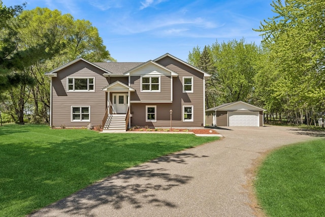 8415 Needham Ave NE, Otsego, MN 55330 - raised ranch featuring an outbuilding, a detached garage, a front yard, and entry steps