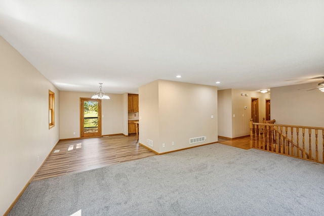 8415 Needham Ave NE, Otsego, MN 55330 - spare room with light carpet, a chandelier, baseboards, recessed lighting, and ceiling fan