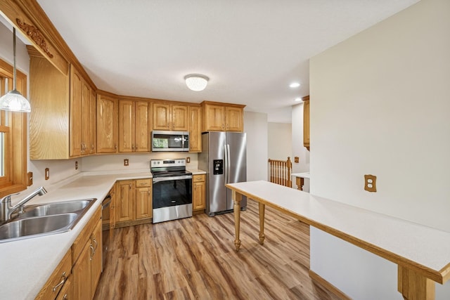8415 Needham Ave NE, Otsego, MN 55330 - kitchen with appliances with stainless steel finishes, a sink, light wood finished floors, light countertops, and recessed lighting