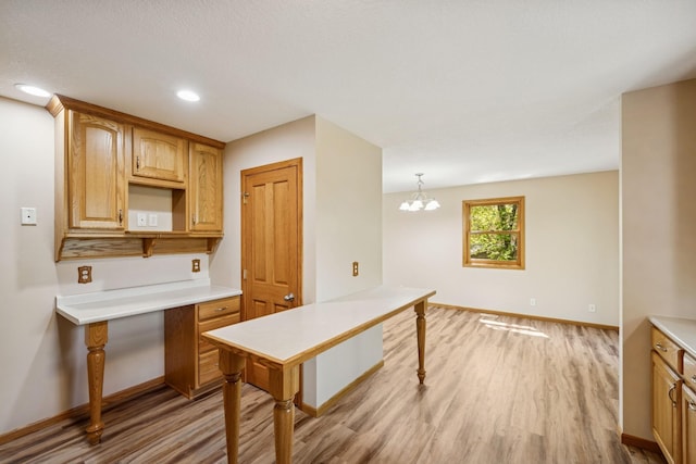 8415 Needham Ave NE, Otsego, MN 55330 - kitchen with light wood-type flooring, light countertops, baseboards, recessed lighting, and a chandelier