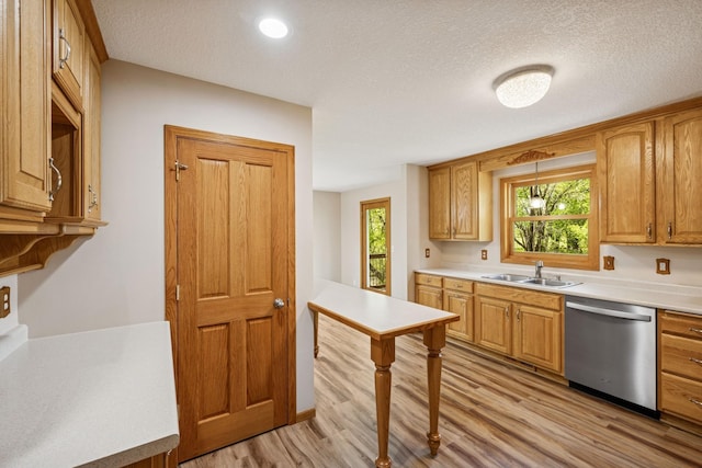 8415 Needham Ave NE, Otsego, MN 55330 - kitchen featuring stainless steel dishwasher, a sink, light wood-type flooring, light countertops, and a textured ceiling