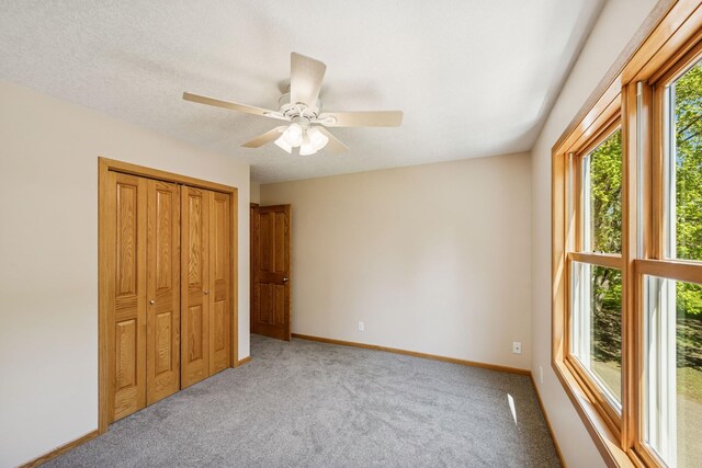 8415 Needham Ave NE, Otsego, MN 55330 - unfurnished bedroom with light carpet, a closet, baseboards, and ceiling fan