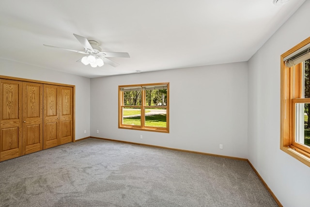 8415 Needham Ave NE, Otsego, MN 55330 - unfurnished bedroom featuring multiple windows, carpet flooring, baseboards, and a ceiling fan
