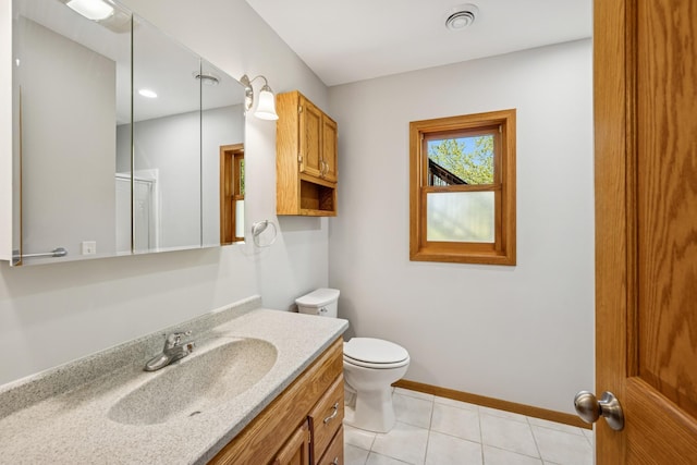 8415 Needham Ave NE, Otsego, MN 55330 - bathroom featuring toilet, vanity, tile patterned flooring, and baseboards