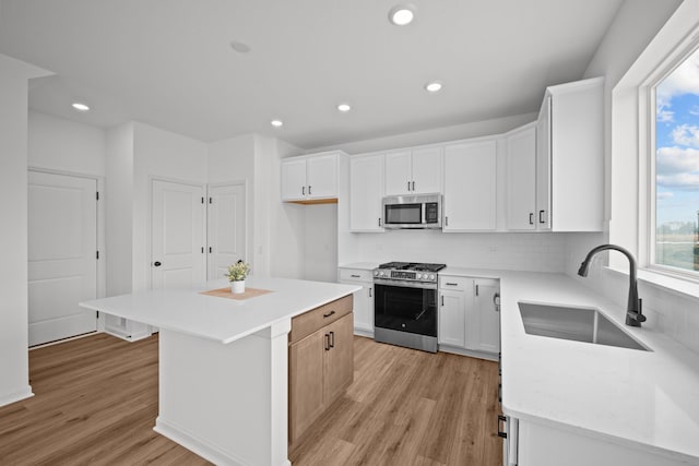 7130 Large Ave NE, Otsego, MN 55301 - kitchen with stainless steel appliances, a sink, light wood finished floors, decorative backsplash, and recessed lighting
