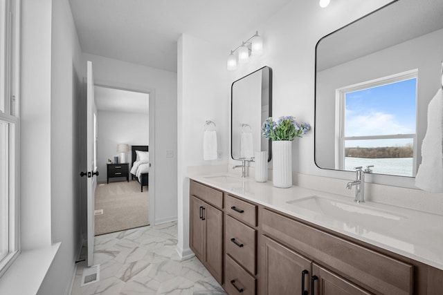 7130 Large Ave NE, Otsego, MN 55301 - full bathroom featuring connected bathroom, marble look tiles, and double vanity