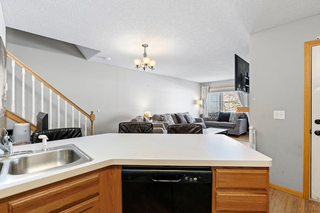 20616 Erin Way Unit 74, Farmington, MN 55024 - kitchen with black dishwasher, light wood-style flooring, a textured ceiling, a chandelier, and light countertops