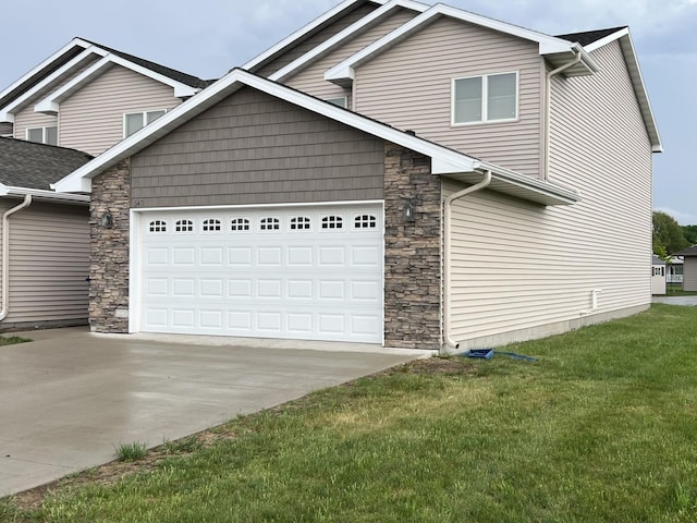 642 Haeberle, New Ulm, MN 56073 - traditional home with stone siding, concrete driveway, a front lawn, and an attached garage