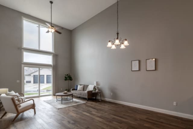 642 Haeberle Ave, New Ulm, MN 56073 - living area featuring high vaulted ceiling, dark wood-style flooring, a chandelier, and ceiling fan