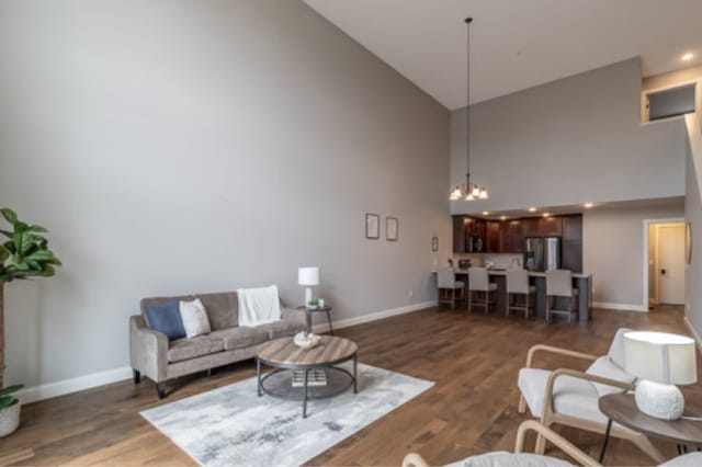 642 Haeberle Ave, New Ulm, MN 56073 - living room with high vaulted ceiling, wood finished floors, and a chandelier