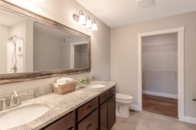642 Haeberle Ave, New Ulm, MN 56073 - full bathroom with double vanity, a walk in closet, and tile patterned floors