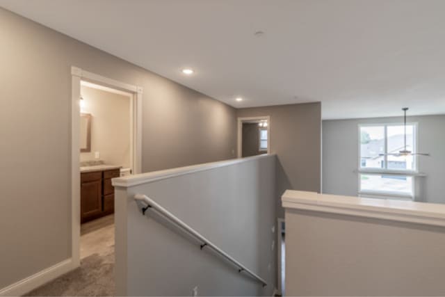 642 Haeberle Ave, New Ulm, MN 56073 - hallway with an upstairs landing, light carpet, and recessed lighting