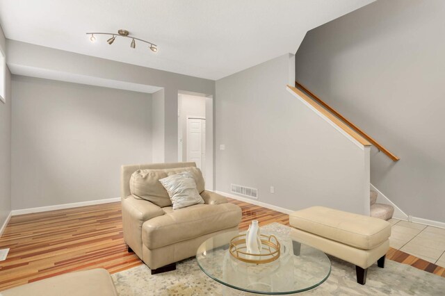 12049 Waconia Cir NE, Blaine, MN 55449 - sitting room featuring wood finished floors, stairs, and baseboards