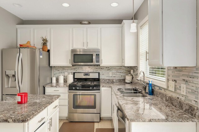 12049 Waconia Cir NE, Blaine, MN 55449 - kitchen with appliances with stainless steel finishes, a sink, plenty of natural light, white cabinetry, and recessed lighting