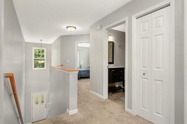 12049 Waconia Cir NE, Blaine, MN 55449 - hallway featuring an upstairs landing, light carpet, and baseboards