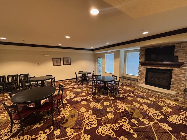 601 Levander Way Unit 311, South Saint Paul, MN 55075 - carpeted dining space with a stone fireplace, crown molding, and recessed lighting