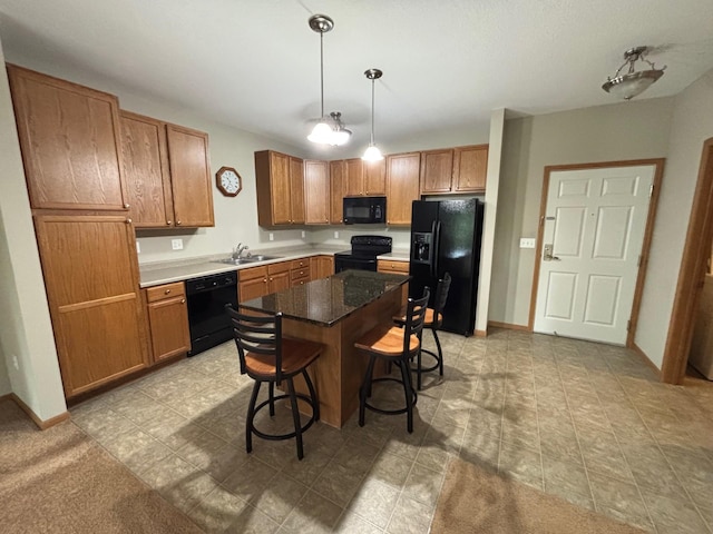 601 Levander Way Unit 311, South Saint Paul, MN 55075 - kitchen with black appliances, a kitchen bar, brown cabinets, hanging light fixtures, and a center island