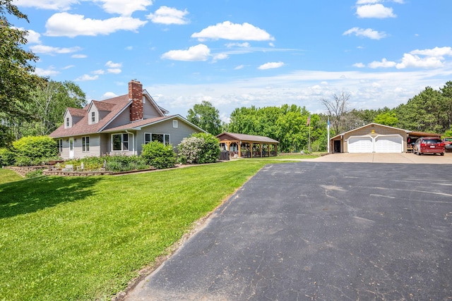 11520 120th St N, Stillwater, MN 55082 - view of front facade featuring a front lawn, driveway, a chimney, and an outbuilding