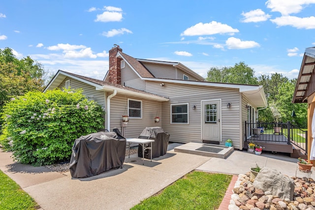 11520 120th St N, Stillwater, MN 55082 - back of house featuring a patio area, a deck, and a chimney
