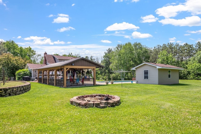 11520 120th St N, Stillwater, MN 55082 - view of grassy yard featuring a gazebo, a fire pit, an outbuilding, and view of scattered trees