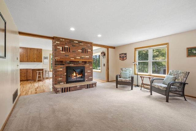 11520 120th St N, Stillwater, MN 55082 - carpeted living room featuring a brick fireplace, baseboards, and recessed lighting