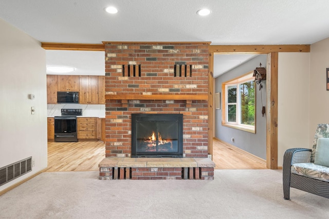 11520 120th St N, Stillwater, MN 55082 - living room with a brick fireplace, light wood finished floors, recessed lighting, baseboards, and light colored carpet