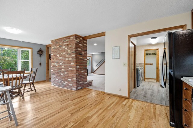11520 120th St N, Stillwater, MN 55082 - dining area with light wood-style flooring, separate washer and dryer, baseboards, and stairs