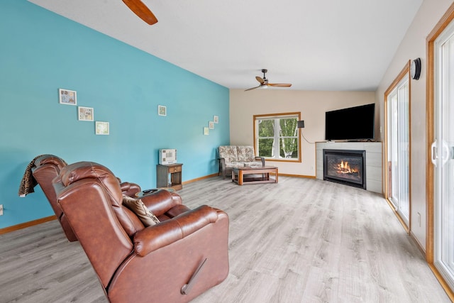 11520 120th St N, Stillwater, MN 55082 - living room featuring ceiling fan, lofted ceiling, light wood finished floors, baseboards, and a tiled fireplace