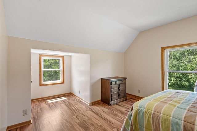 11520 120th St N, Stillwater, MN 55082 - bedroom featuring multiple windows, lofted ceiling, light wood-style flooring, and baseboards