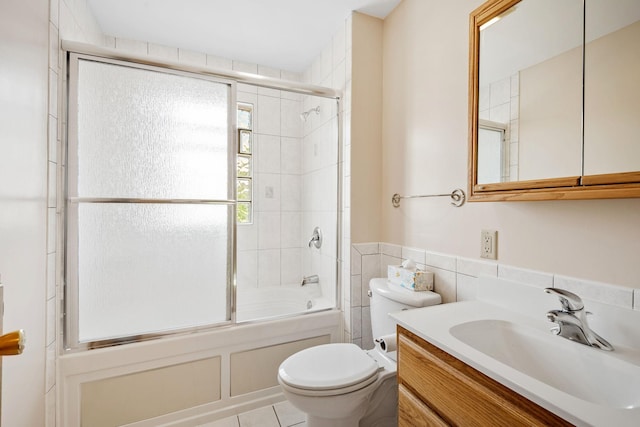 11520 120th St N, Stillwater, MN 55082 - bathroom with toilet, vanity, combined bath / shower with glass door, tile walls, and tile patterned floors