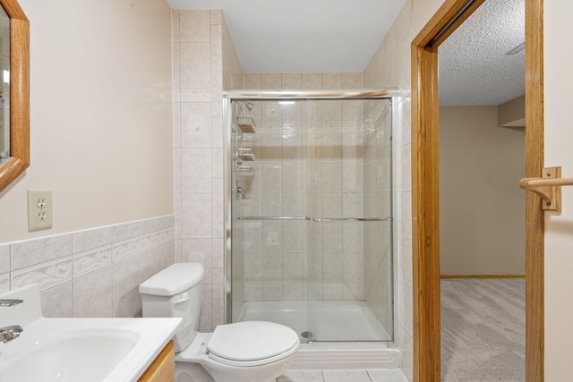 11520 120th St N, Stillwater, MN 55082 - full bathroom featuring toilet, a shower stall, tile walls, vanity, and wainscoting