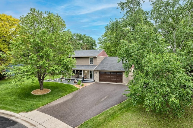 1144 Waldon Pl, Arden Hills, MN 55112 - view of front facade with driveway, a front lawn, a garage, a shingled roof, and a porch