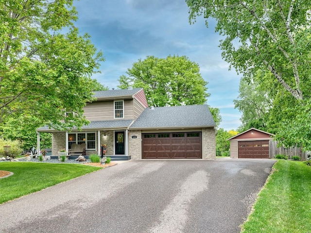 1144 Waldon Pl, Arden Hills, MN 55112 - traditional-style home featuring a front lawn, roof with shingles, a detached garage, brick siding, and a porch