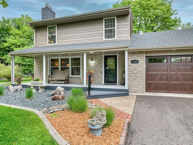 1144 Waldon Pl, Arden Hills, MN 55112 - view of front of property featuring covered porch, a chimney, stone siding, an attached garage, and a shingled roof