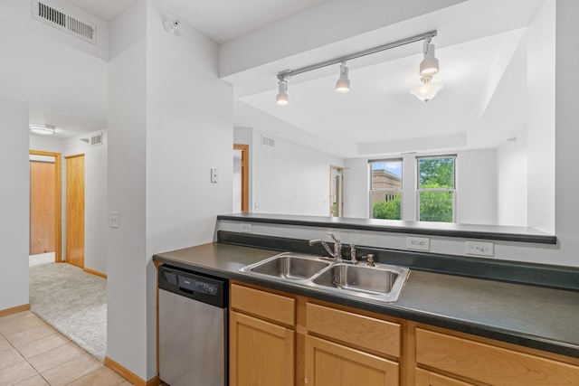 560 2nd St Unit 408, Minneapolis, MN 55401 - kitchen with stainless steel dishwasher, a sink, dark countertops, light tile patterned floors, and baseboards
