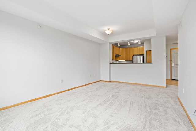 560 2nd St Unit 408, Minneapolis, MN 55401 - unfurnished living room featuring light carpet and baseboards