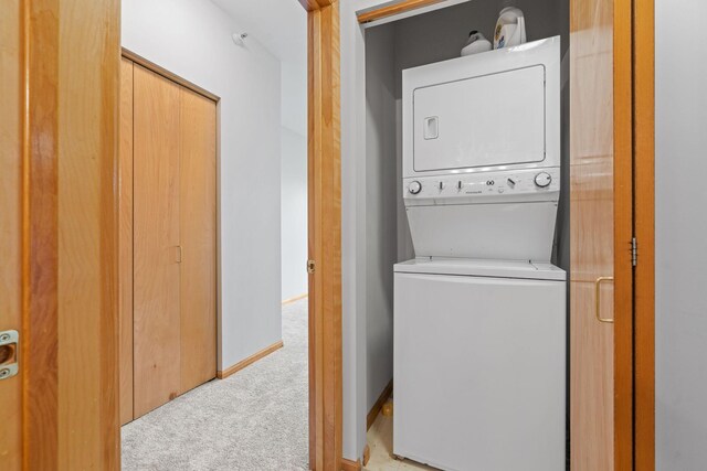 560 2nd St Unit 408, Minneapolis, MN 55401 - laundry room featuring stacked washing machine and dryer and carpet flooring