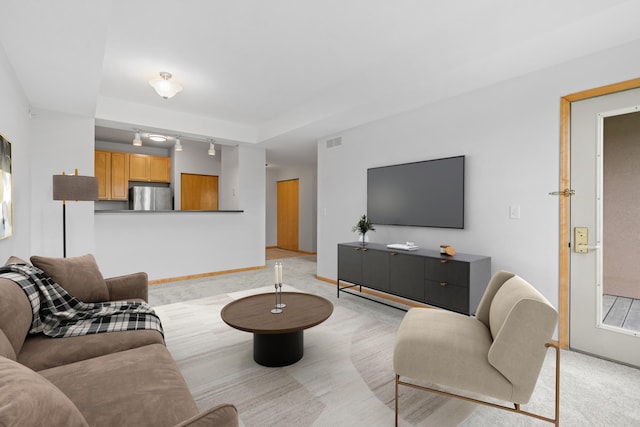560 2nd St Unit 408, Minneapolis, MN 55401 - living room with light carpet, baseboards, and rail lighting