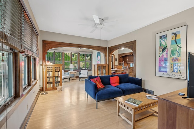1441 Simpson St, Saint Paul, MN 55108 - living area featuring arched walkways, a ceiling fan, and light wood finished floors