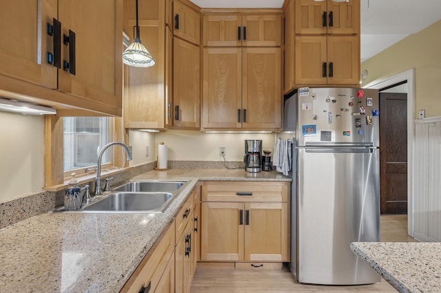 1441 Simpson St, Saint Paul, MN 55108 - kitchen featuring freestanding refrigerator, light wood-type flooring, light stone counters, and hanging light fixtures