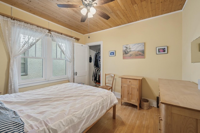 1441 Simpson St, Saint Paul, MN 55108 - bedroom featuring ornamental molding, light wood-style flooring, a spacious closet, a closet, and ceiling fan