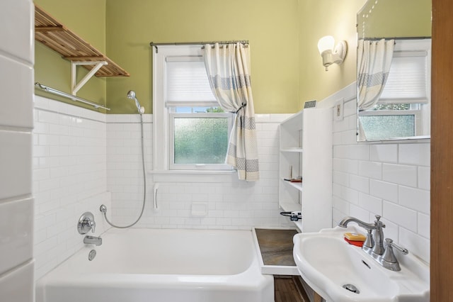 1441 Simpson St, Saint Paul, MN 55108 - bathroom with tile walls, bathtub / shower combination, and a wainscoted wall
