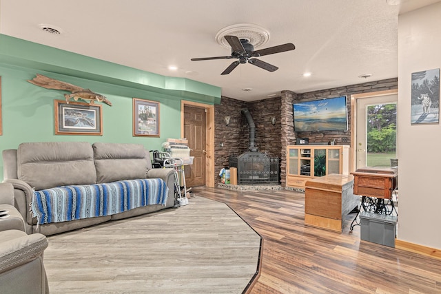 4480 253rd Ave NW, Isanti, MN 55040 - living area with a wood stove, wood finished floors, and a ceiling fan