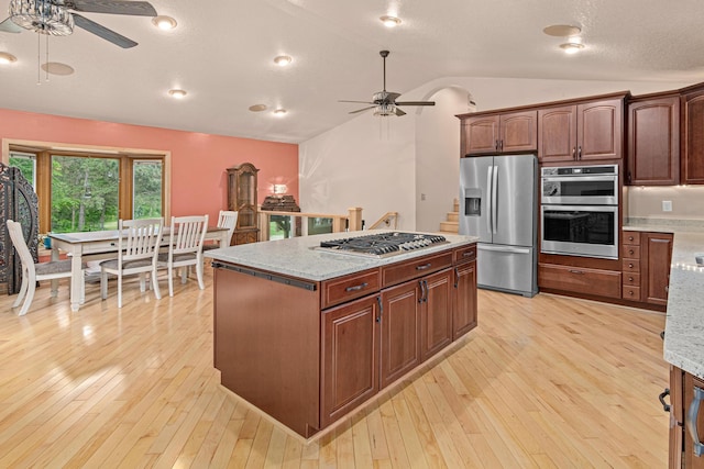 4480 253rd Ave NW, Isanti, MN 55040 - kitchen with ceiling fan, stainless steel appliances, vaulted ceiling, and light wood-style floors