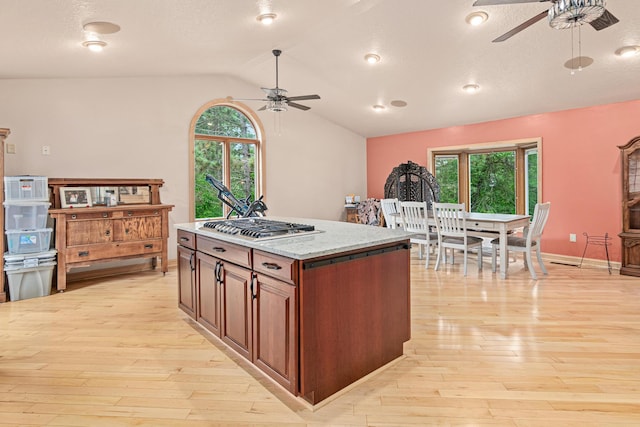 4480 253rd Ave NW, Isanti, MN 55040 - kitchen featuring ceiling fan, stainless steel gas cooktop, light wood-type flooring, and lofted ceiling