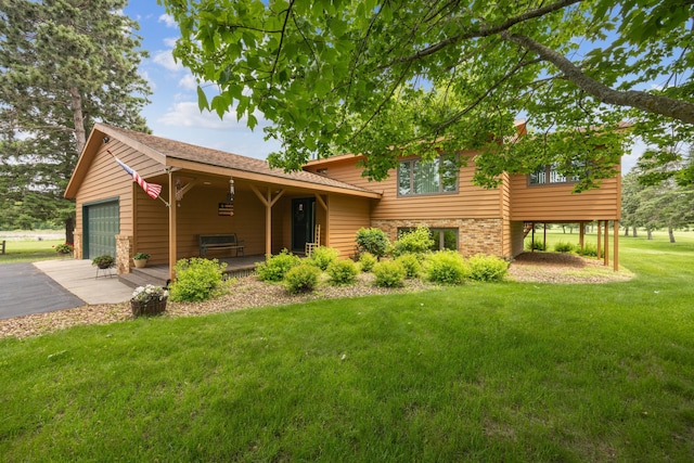 3922 County Road 136, Saint Cloud, MN 56301 - split level home with a front lawn, a garage, asphalt driveway, and covered porch