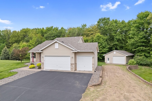 18358 Jenkins St NE, East Bethel, MN 55011 - view of front of property with a front lawn, an outbuilding, a garage, and stone siding