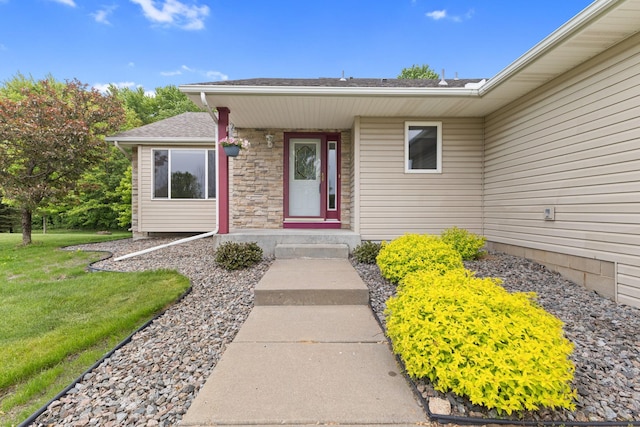 18358 Jenkins St NE, East Bethel, MN 55011 - property entrance with a yard, stone siding, and roof with shingles