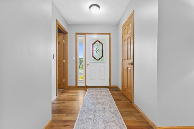 18358 Jenkins St NE, East Bethel, MN 55011 - entrance foyer with baseboards, light wood-type flooring, and a textured ceiling