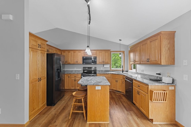 18358 Jenkins St NE, East Bethel, MN 55011 - kitchen featuring black refrigerator with ice dispenser, range with electric cooktop, stainless steel microwave, dishwashing machine, and vaulted ceiling